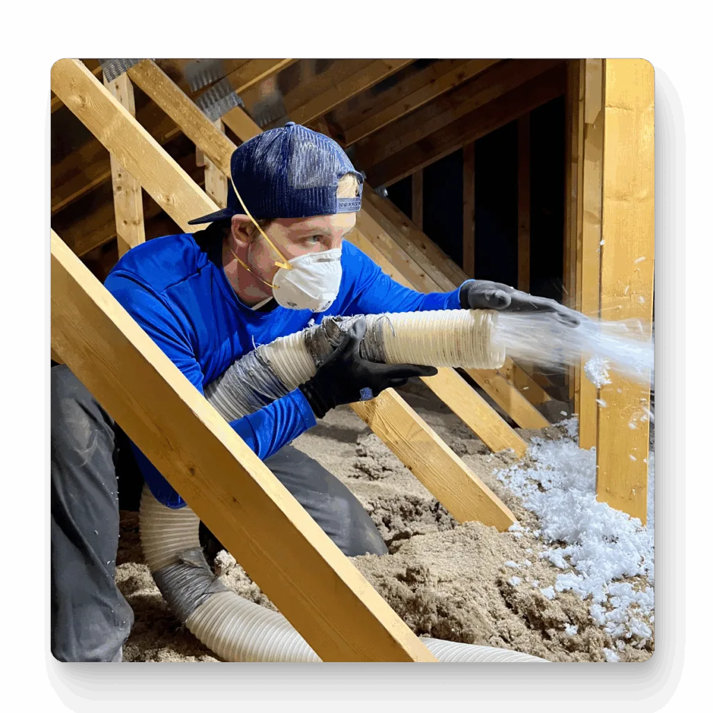Arizona technician vacuuming out damaged attic insulation to prepare for upgrade.