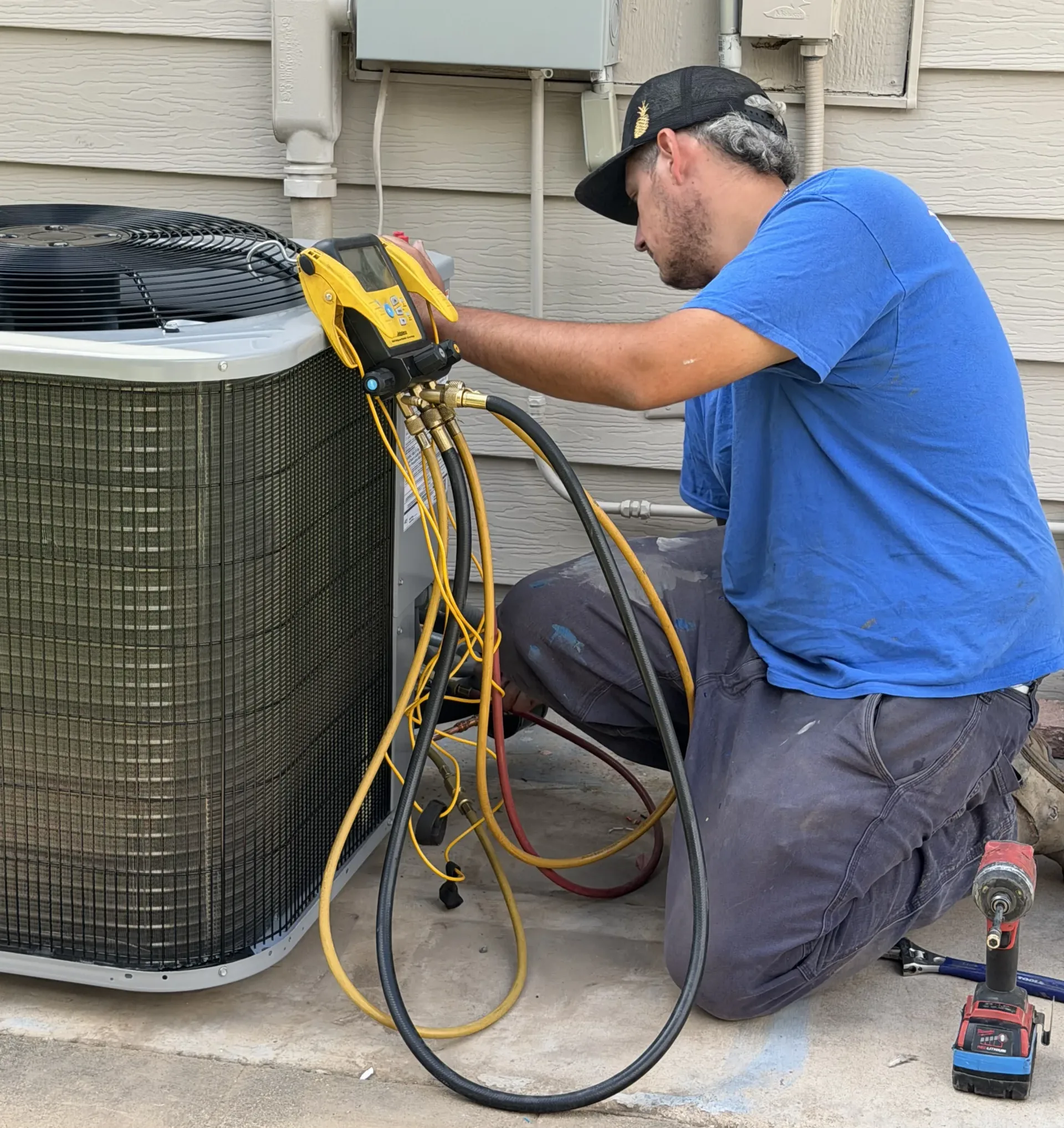 HVAC technician performing a free AC inspection in Mesa, AZ checking system performance for Arizona home