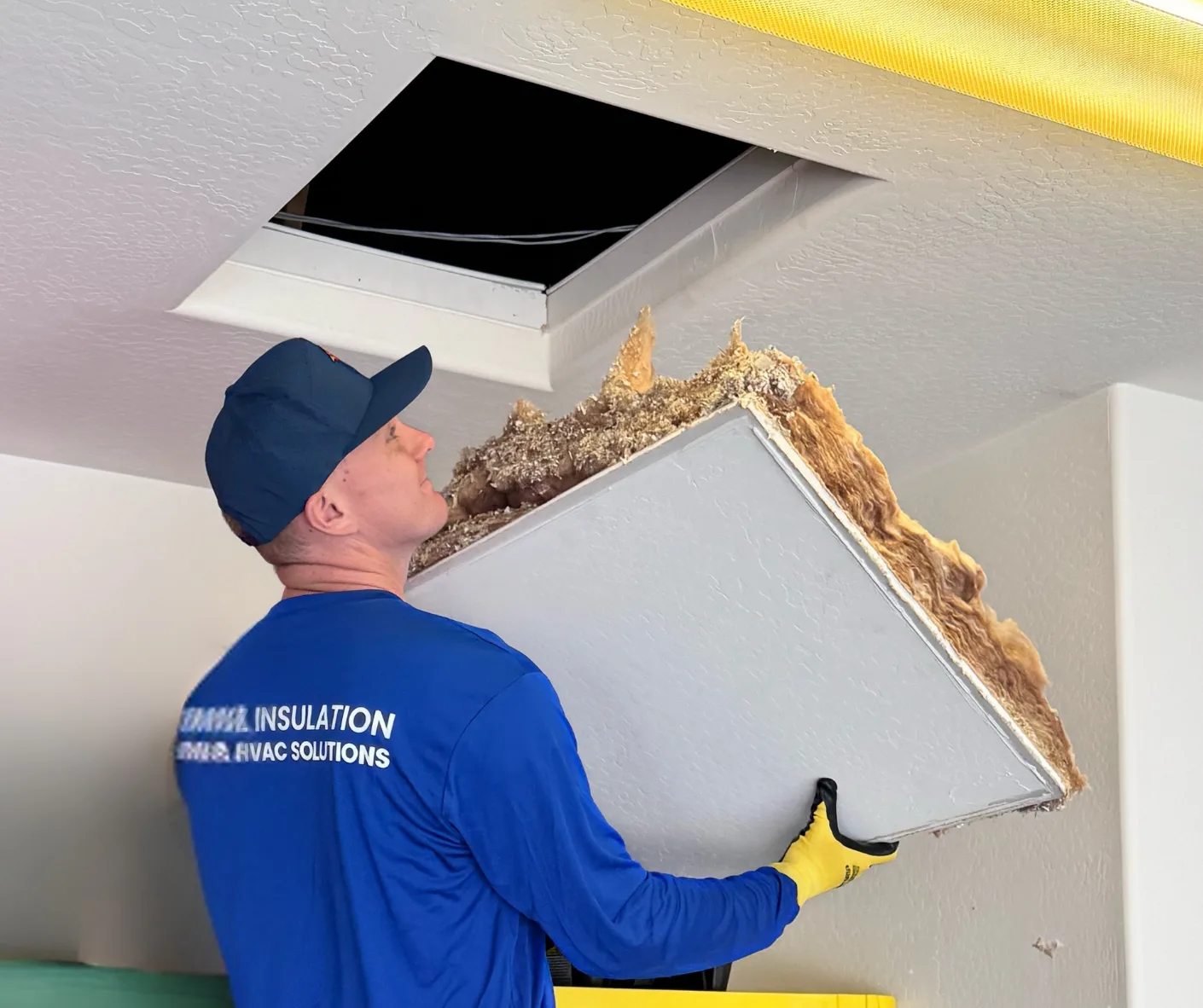 Technician inspecting a hot attic in Phoenix Arizona