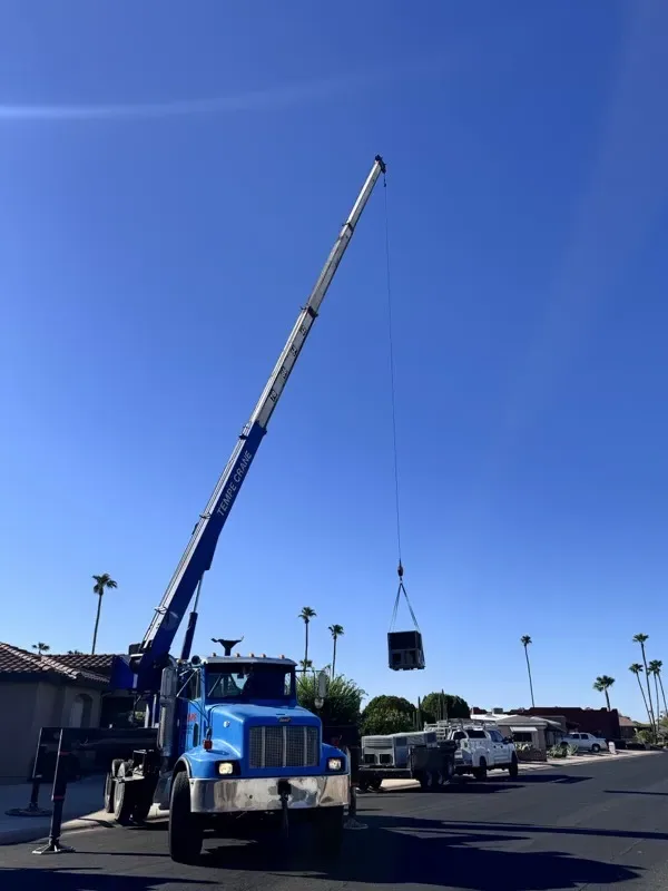 New rooftop HVAC package unit craned into place on an Apache Junction home