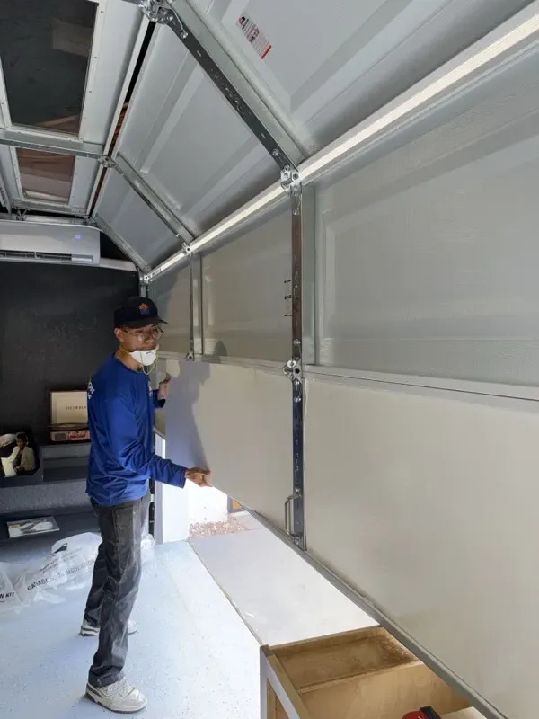 Technician installing garage door insulation panels in Glendale