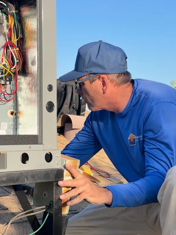 AZ Insulation technician repairing a rooftop HVAC unit in Tempe, Arizona