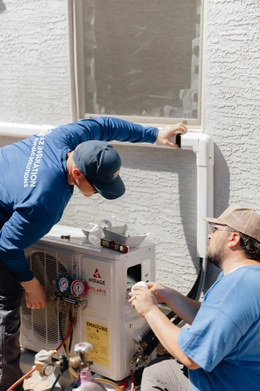 AZ Insulation team installing a Mirage ductless mini-split in a Tempe living room