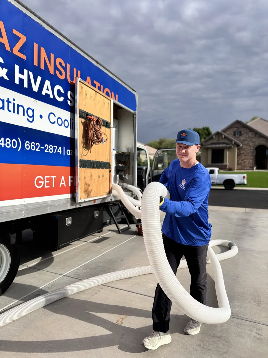 A blower hose running from the AZ Insulation truck up a Chandler driveway