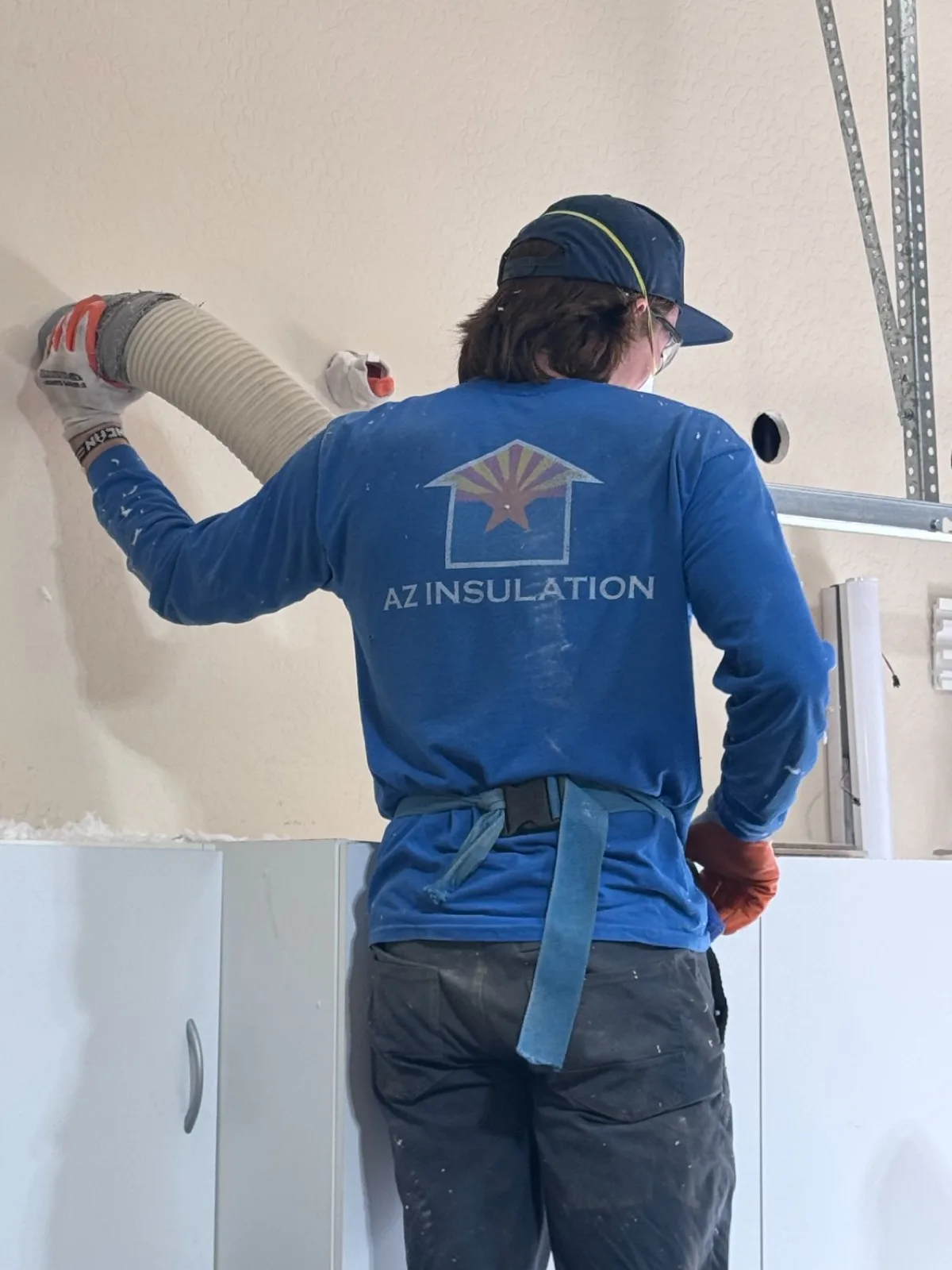 Wall cavity filled with blown insulation